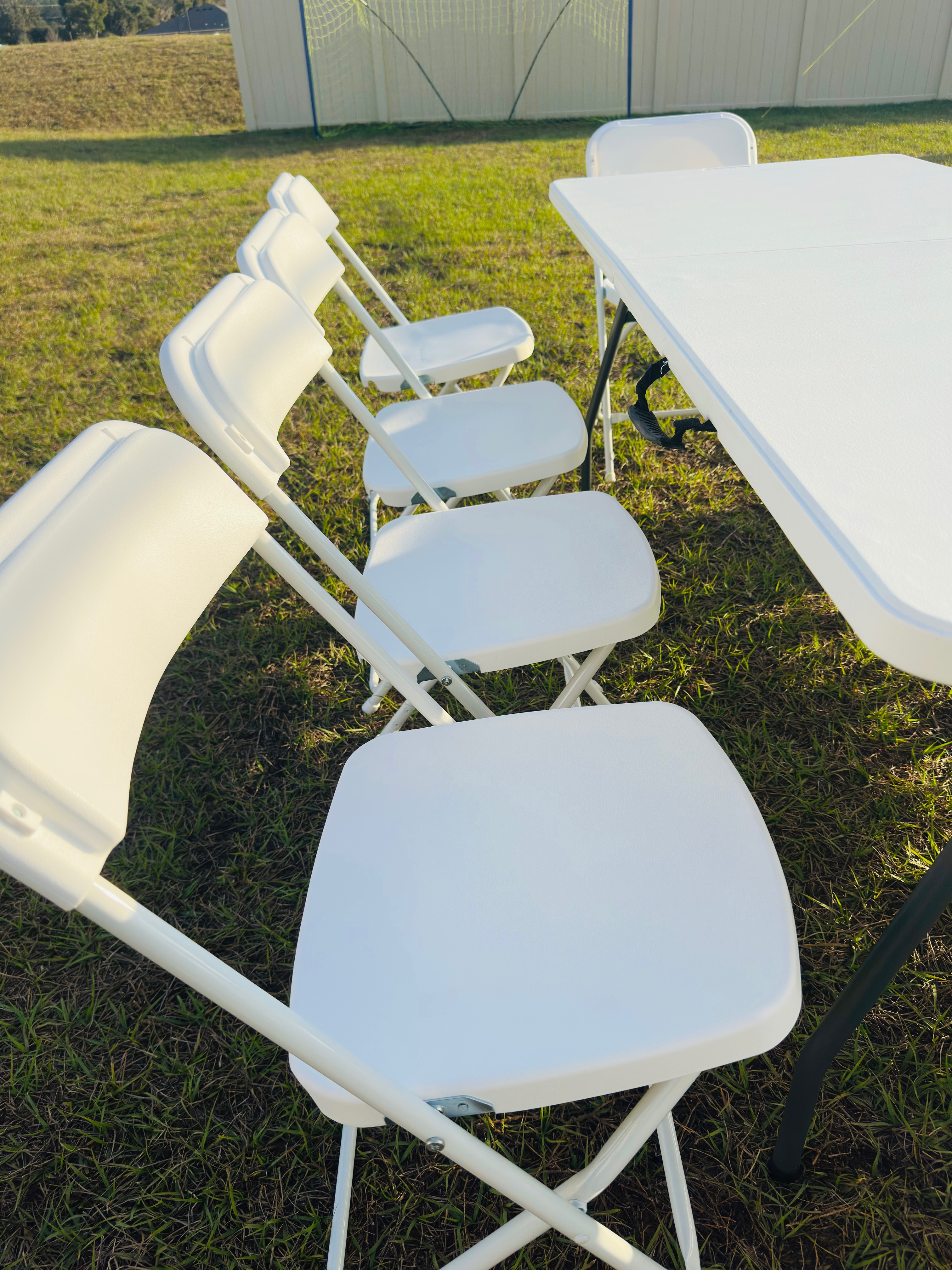 Clean white folding chairs and table